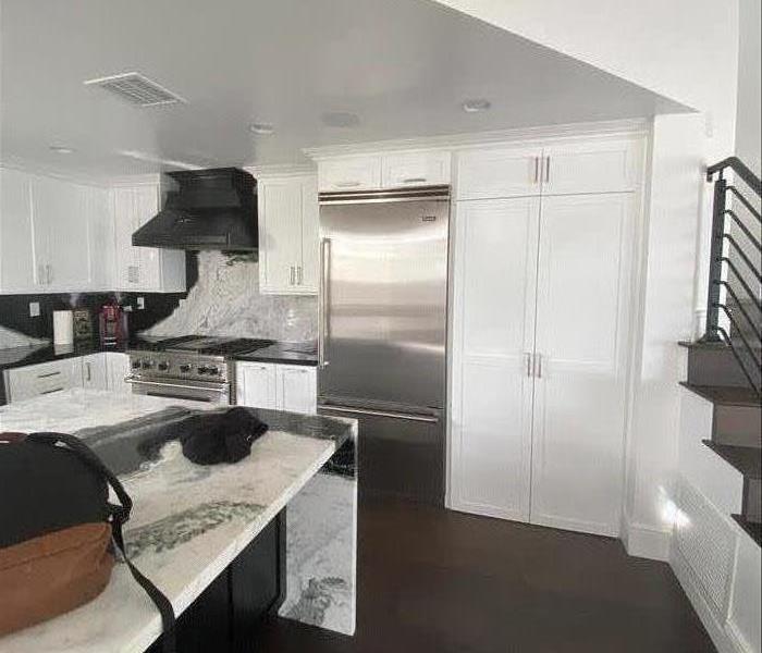 Renovated Kitchen with White Cabinets and Marble Countertop
