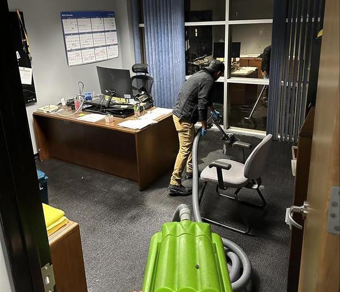 Technician extracting water from a commercial office